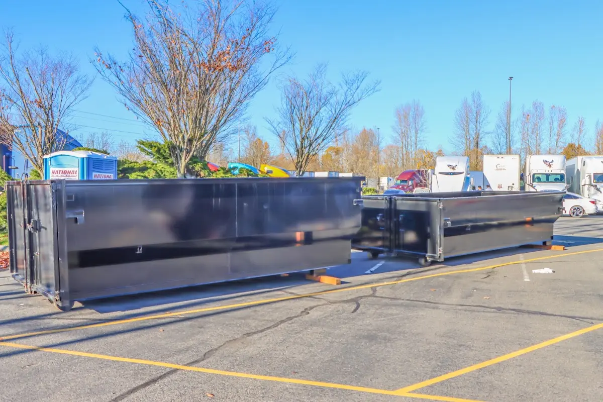 Professional dumpster rental service with roll-off container on residential driveway in Owatonna